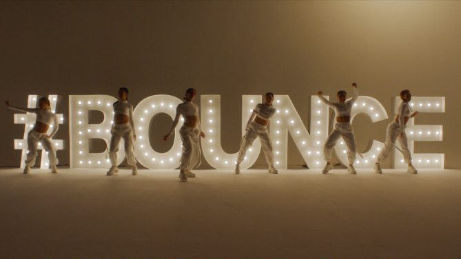 woman infront of bounce sign